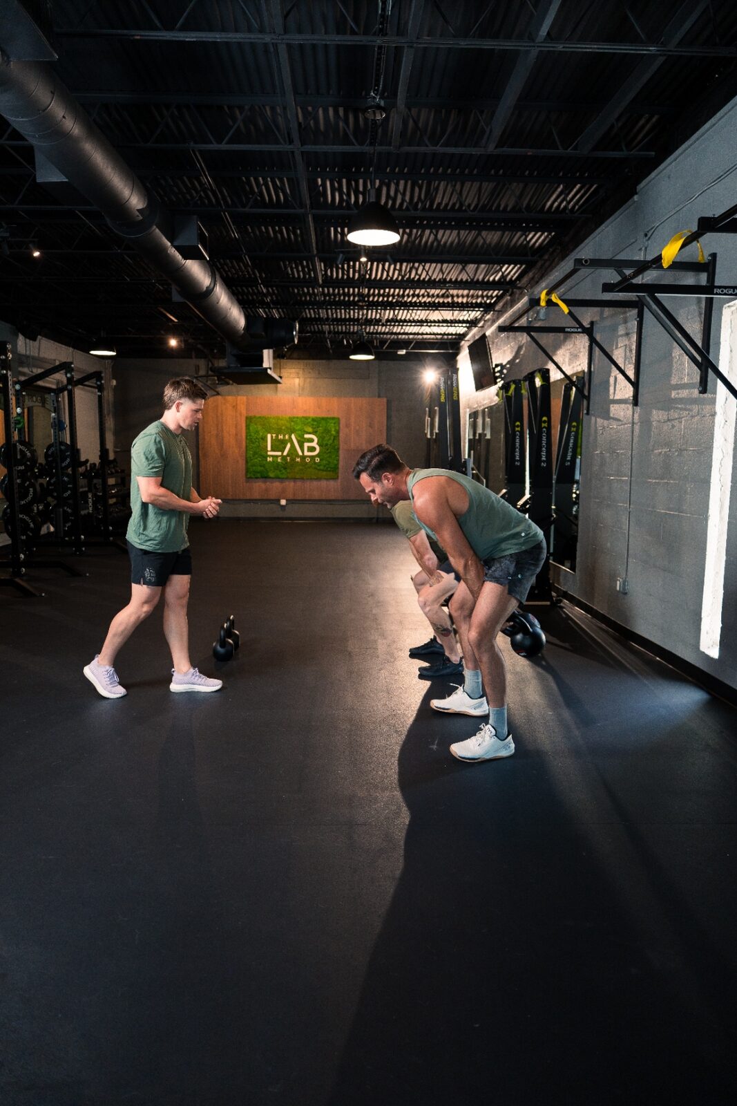 Dylan coaching kettlebell work inside The Lab studio