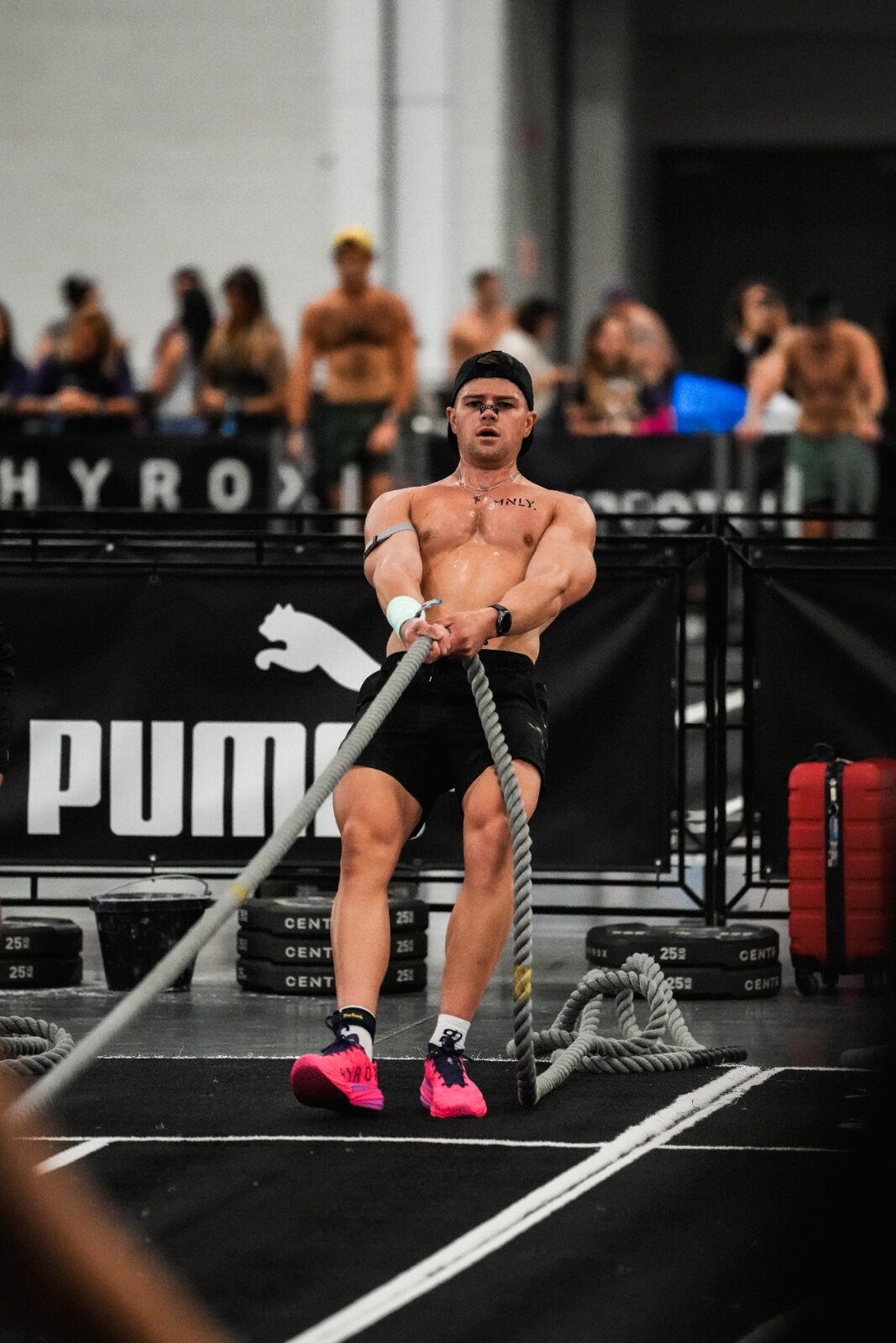 Dylan pulling a heavy rope during a Hyrox competition